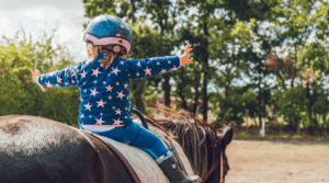 young child horseback riding lesson