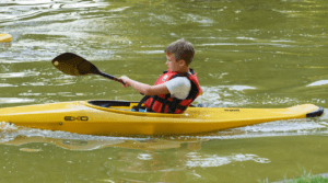 child solo kayaking in the low country