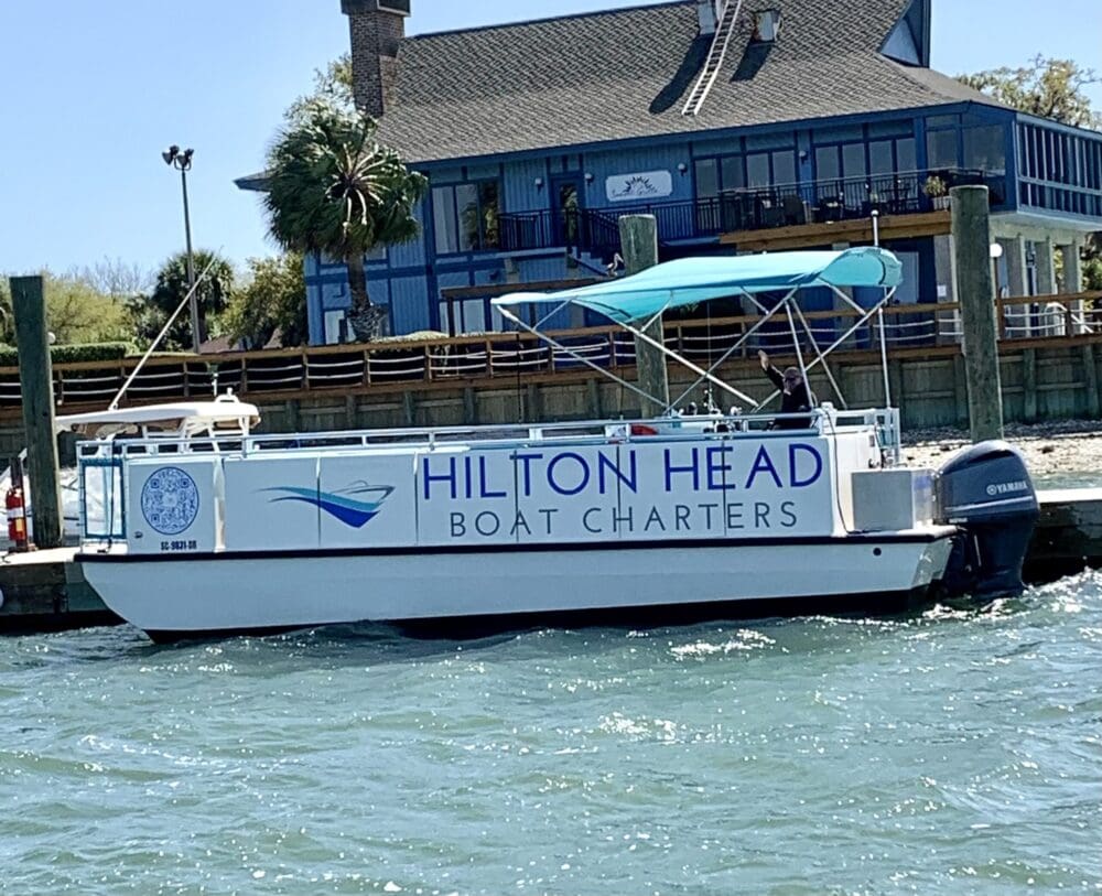 A scenic view of a boat charter on Hilton Head, showcasing the tranquil waters and lush surroundings.