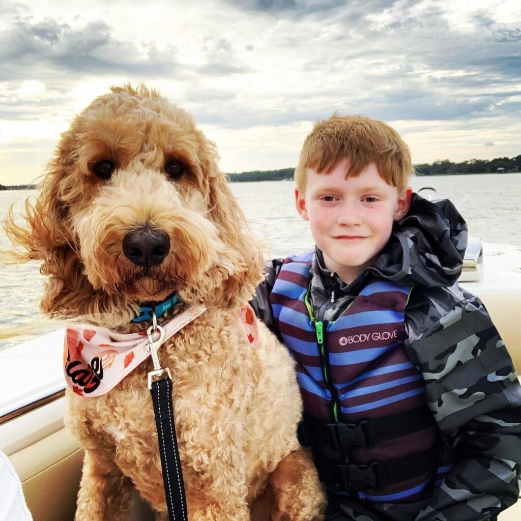 Happy child and doodle on board Hilton Head Boat Charters