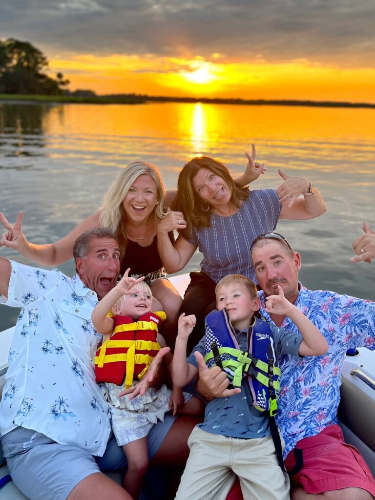 Family mugging for the camera hilariously during amazing sunset cruise