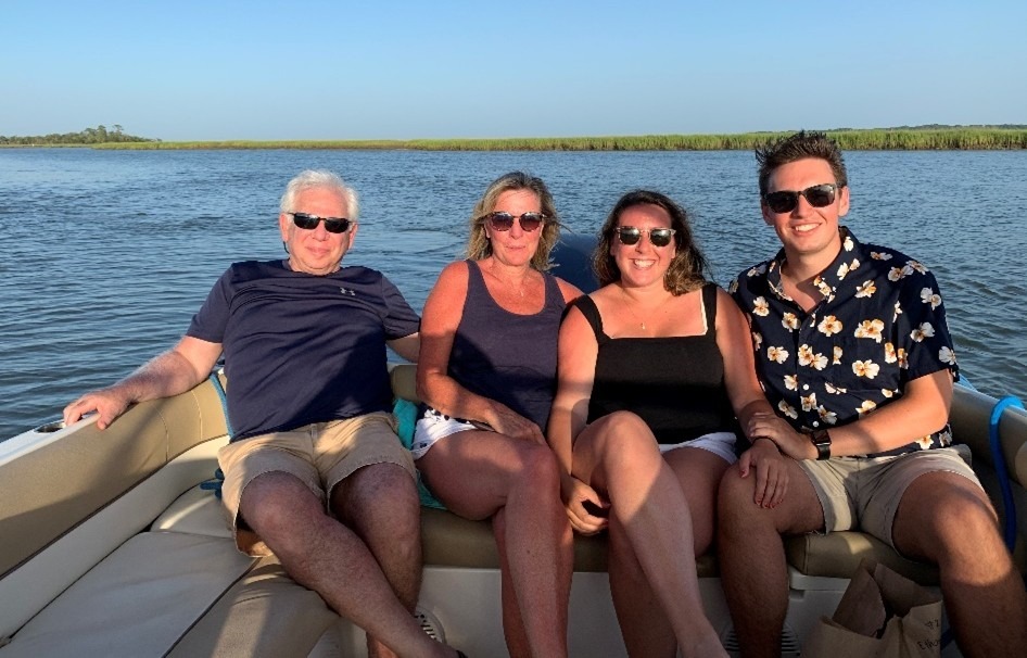 Family comfortably dressed on a summer sunset cruise