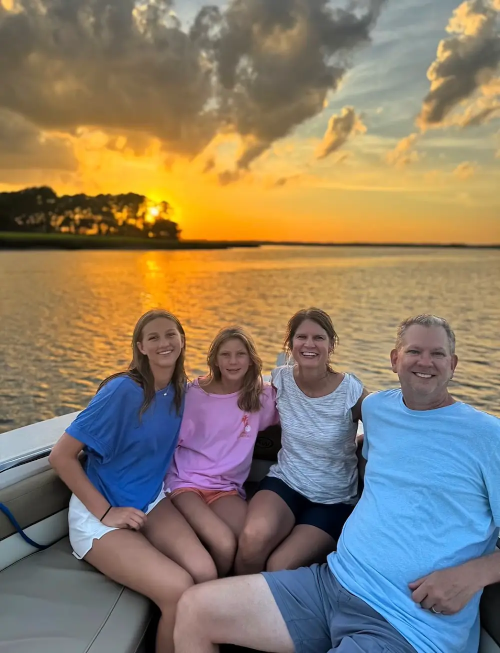 family enjoying a private dolphin tour with Hilton Head Boat Charters at sunset